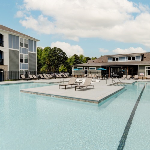 Relax by the Saltwater Pool at Aldon at Powell & Broad Saltwater pool with sunbathing platform at Aldon at Powell & Broad Apartments in Fuquay-Varina, NC.