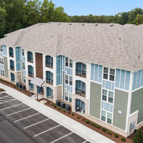View of Aldon at Powell & Broad Building  and Parking Outdoor view of the buildings at Aldon at Powell & Broad, showcasing the apartment buildings and parking spaces in Fuquay-Varina, NC.